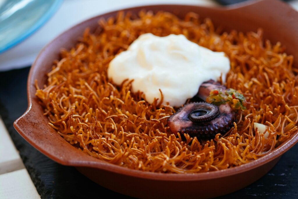 Delicious octopus dish with crispy vermicelli topped with aioli.